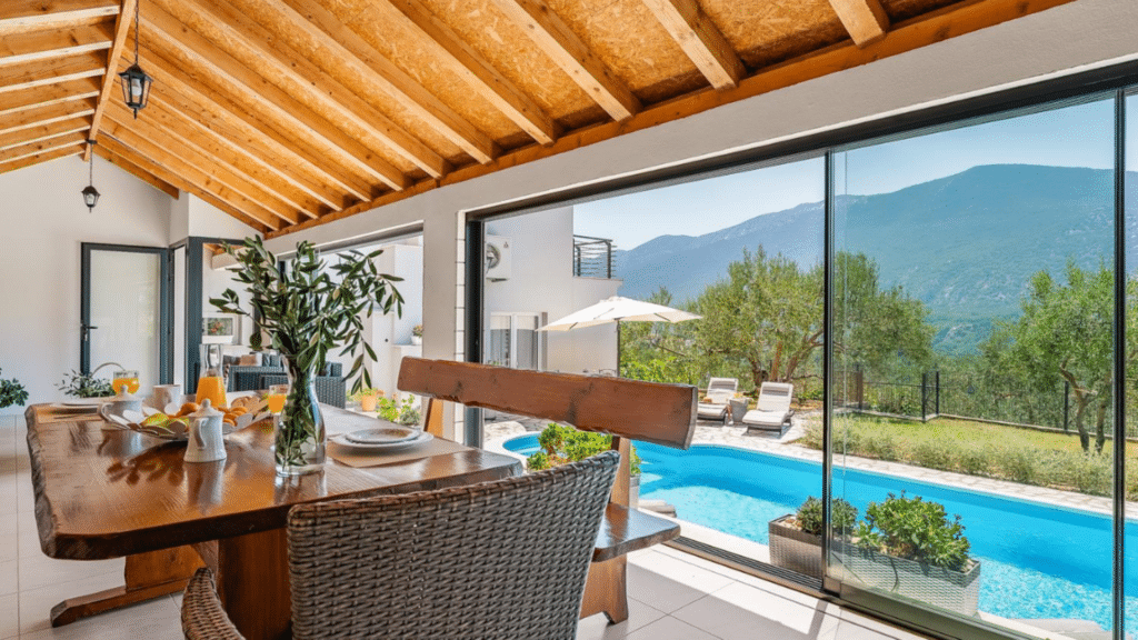 Covered outdoor dining overlooking the private pool and mountain views at a Croatia villa in Omis