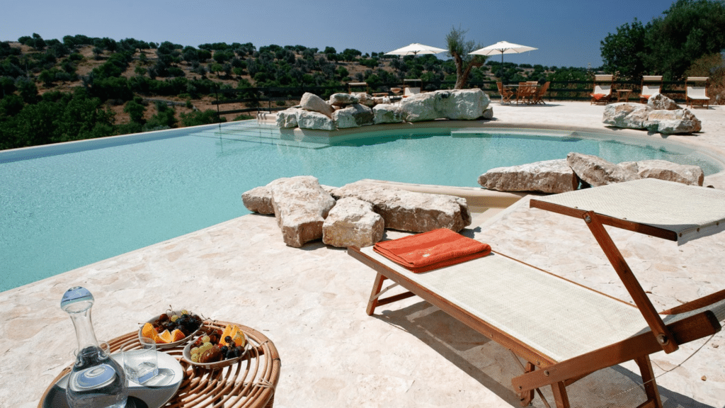 Infinity pool overlooking olive groves at a private Sicily estate included in the Sicilian Sunsets auction package.