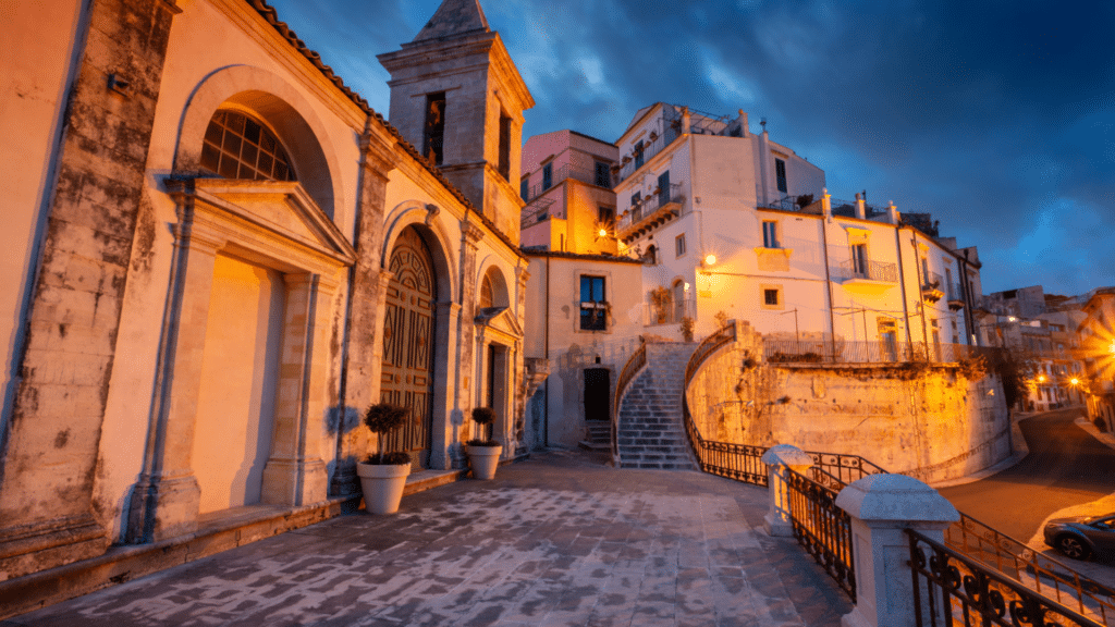 Historic streets and Baroque architecture in Ragusa, Sicily during an evening guided tour.