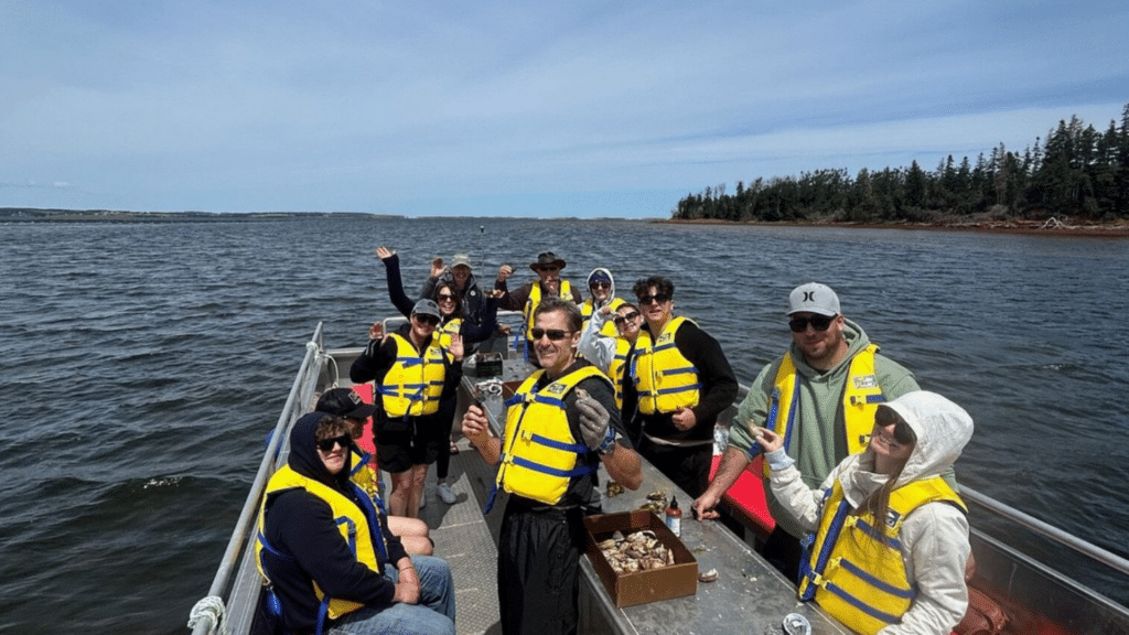 Guests enjoying a guided oyster farm tour and tasting experience in Prince Edward Island.