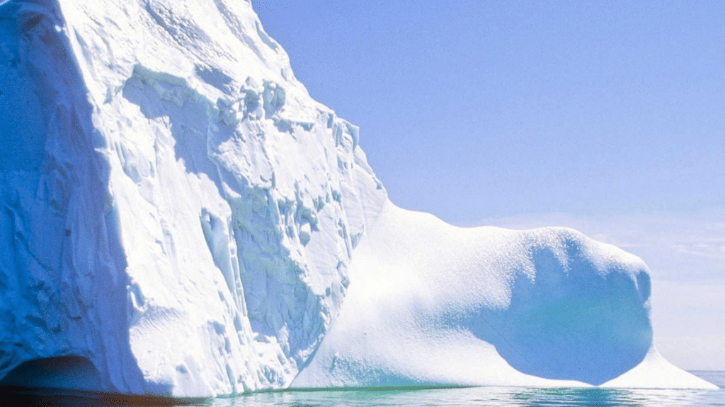 Seasonal iceberg floating in Iceberg Alley off Newfoundland's dramatic Atlantic coastline.