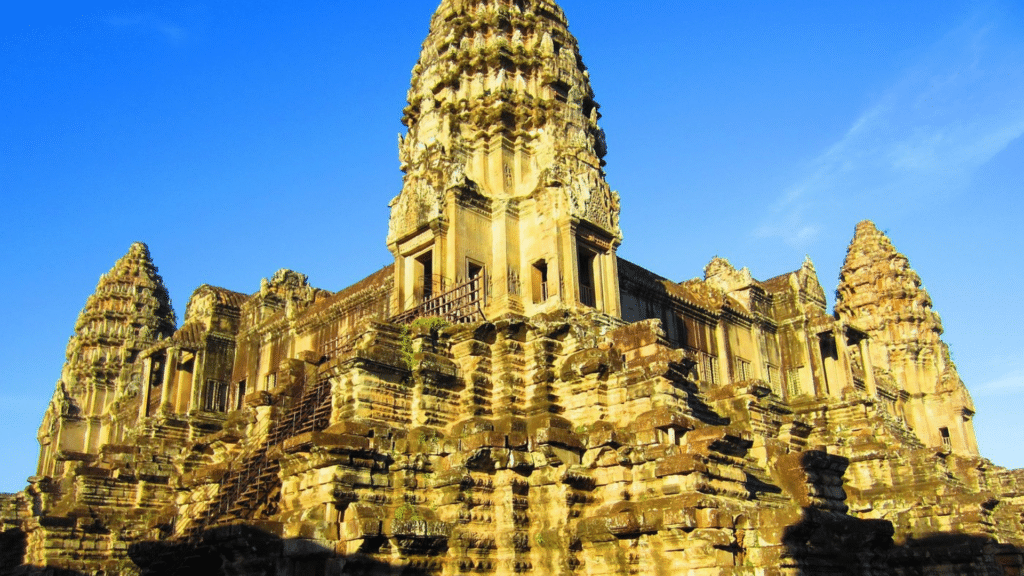 Historic Angkor Wat temple illuminated beneath a blue Cambodian sky