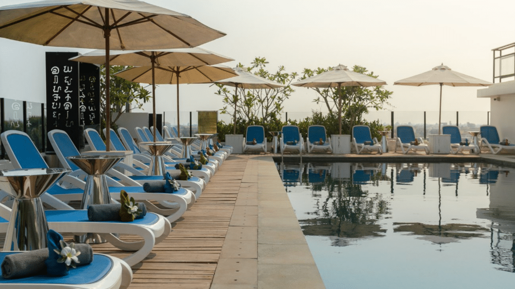 Pool terrace with lounge chairs at Hari Residence & Spa